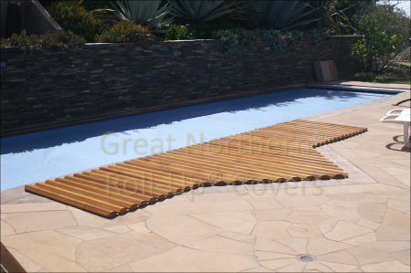 <p>Custom cedar roll-up cover on an in-ground poolside spa with a flagstone deck.</p>