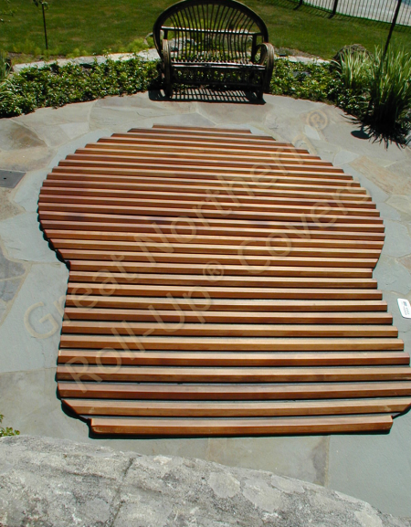 <p>Natural wood Roll-Up® Cover on an in-ground spa, built level to the ground.</p>