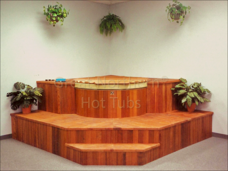 <p>Indoor round cedar hot tub built into large modular steps and seating.</p>