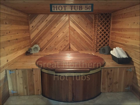 <p>Great Northern western red cedar hot tub in a creative indoor installation.</p>