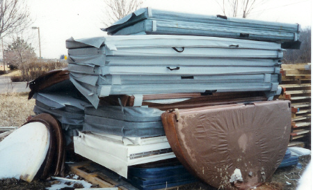 <p>Pile of discarded, water-logged foam spa covers.</p>
