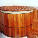 Indoor redwood hot tub with a custom rollup cover for easy protection and elegant design