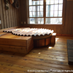 Indoor redwood hot tub with a custom rollup cover for sleek protection and style