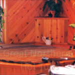 Indoor redwood hot tub with a rollup cover for efficient protection and sleek design