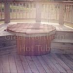 Custom cedar decking built around a cedar hot tub for a polished and integrated outdoor look