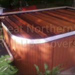 Outdoor redwood hot tub with a custom-fit rollup cover for protection and durability