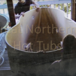 People assembling a hot tub with care and attention to detail