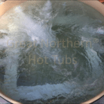 Cedar hot tub with bubbling water, creating a soothing and spa-like experience