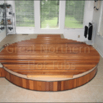 Indoor cedar hot tub with a rollup cover in a cozy, relaxing room ambiance