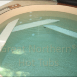 Hot tub built into a wooden deck for a seamless and luxurious outdoor setup