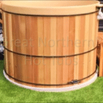 Cedar hot tub placed on a spacious outdoor lawn, perfect for open-air relaxation