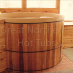 Indoor cedar hot tub with custom shelving built around it for a functional and stylish design