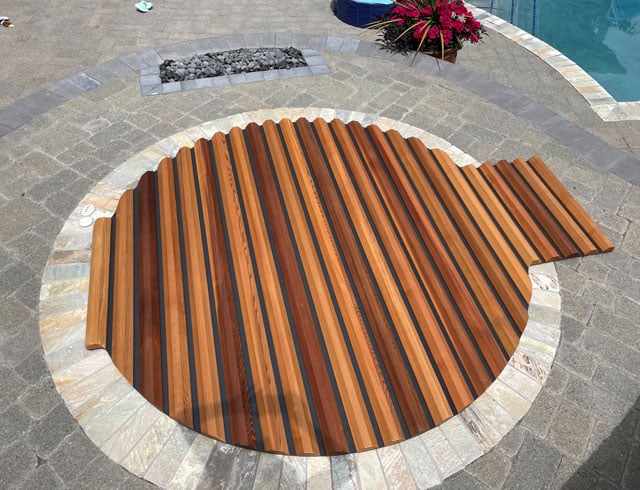 Striking two-tone roll-up cover adds bold beauty and protection to your round cedar hot tub.