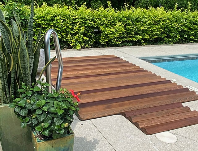 Sleek roll-up cover adds a modern touch while keeping your hot tub protected by the poolside.