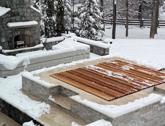 Cedar roll-up cover stands strong through winter, keeping your hot tub ready in any season.